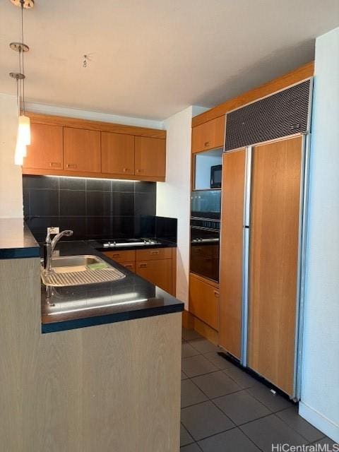 1330 Ala Moana Blvd Unit 1507, Honolulu, HI 96814 - kitchen with black appliances, decorative backsplash, a sink, dark tile patterned floors, and pendant lighting