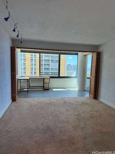 1330 Ala Moana Blvd Unit 1507, Honolulu, HI 96814 - spare room with plenty of natural light, carpet flooring, and rail lighting