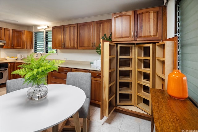 1456 Ala Aolani St, Honolulu, HI 96819 - kitchen featuring stainless steel oven, brown cabinetry, light tile patterned floors, ventilation hood, and light countertops