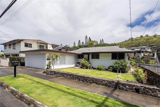 1456 Ala Aolani St, Honolulu, HI 96819 - view of front of home with an attached garage, asphalt driveway, and a front lawn