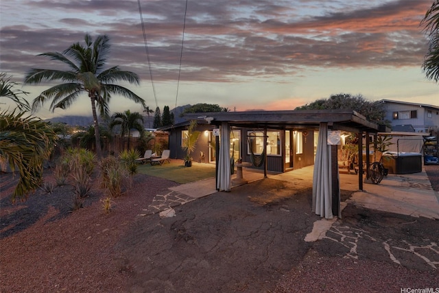 86-94 Pokai Bay St, Waianae, HI 96792 - back of property at dusk featuring a patio area and driveway