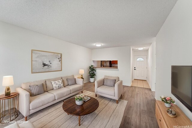 94-1467 Waipio Uka St Unit T103, Waipahu, HI 96797 - living area featuring a textured ceiling and wood finished floors