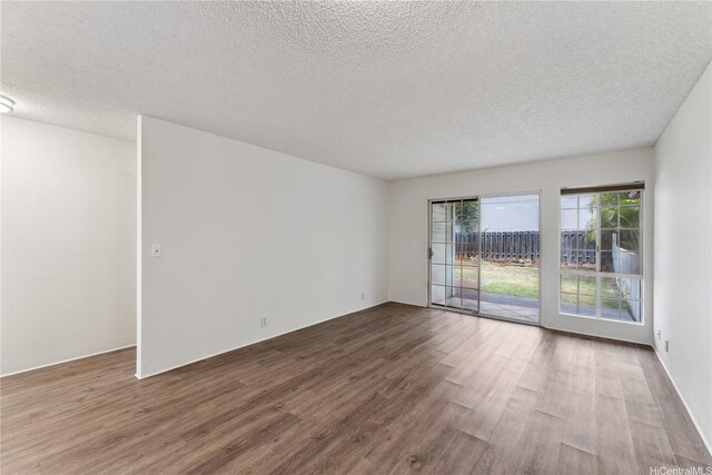 94-1467 Waipio Uka St Unit T103, Waipahu, HI 96797 - unfurnished room with wood finished floors and a textured ceiling