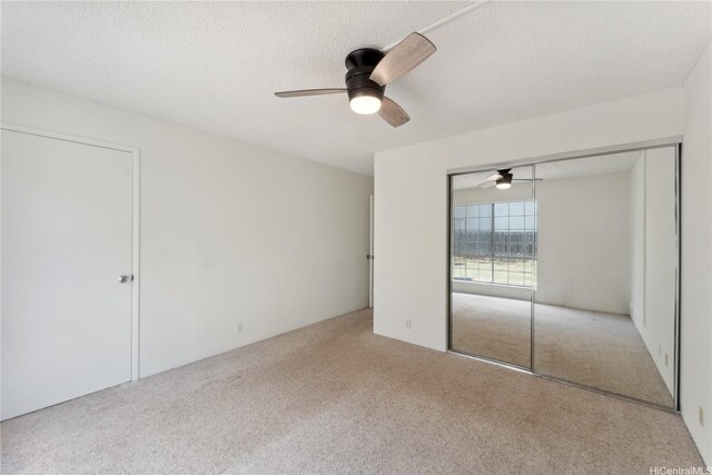 94-1467 Waipio Uka St Unit T103, Waipahu, HI 96797 - unfurnished bedroom featuring carpet floors, a closet, ceiling fan, and a textured ceiling