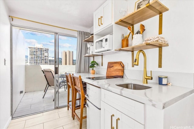 2463 Kuhio Ave Unit 1109, Honolulu, HI 96815 - kitchen featuring open shelves, white cabinetry, a view of city, light stone counters, and white microwave