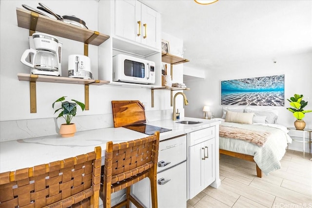 2463 Kuhio Ave Unit 1109, Honolulu, HI 96815 - kitchen with white microwave, open shelves, and white cabinetry