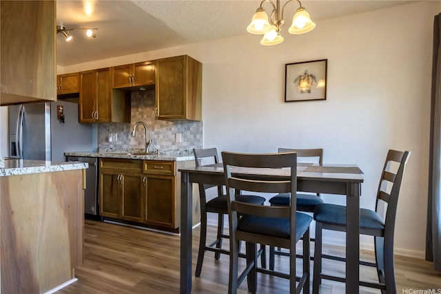 94-1147 Mopua Loop Unit K8, Waipahu, HI 96797 - kitchen featuring backsplash, a chandelier, appliances with stainless steel finishes, dark wood-type flooring, and a textured ceiling