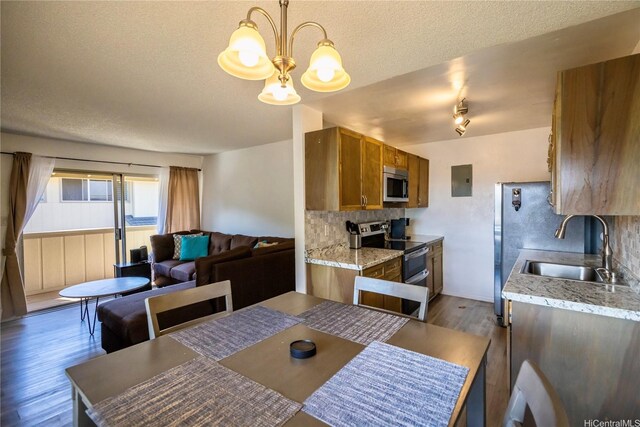 94-1147 Mopua Loop Unit K8, Waipahu, HI 96797 - dining space featuring dark wood-style flooring, a textured ceiling, a chandelier, and electric panel