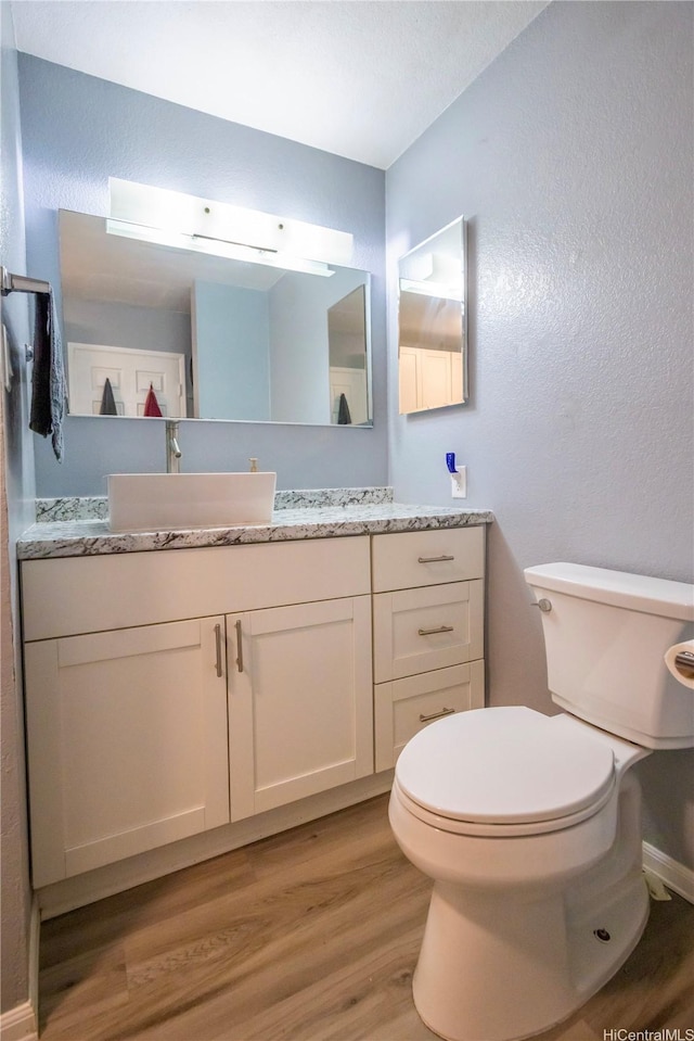 94-1147 Mopua Loop Unit K8, Waipahu, HI 96797 - bathroom featuring wood finished floors, a textured wall, and vanity