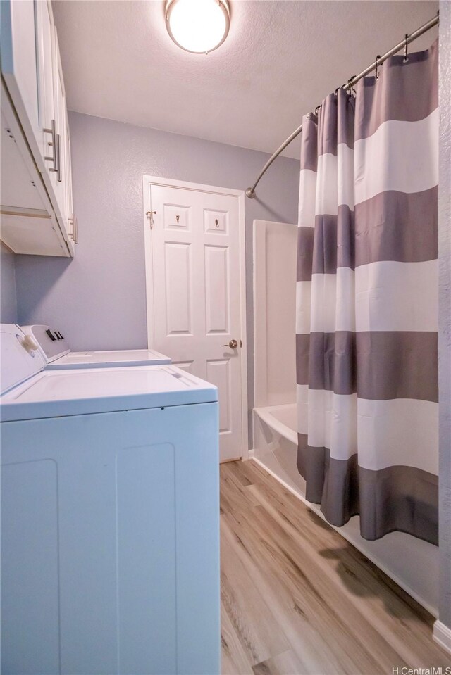 94-1147 Mopua Loop Unit K8, Waipahu, HI 96797 - laundry room featuring separate washer and dryer, light wood-type flooring, and a textured ceiling