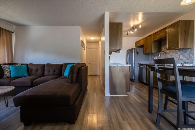 94-1147 Mopua Loop Unit K8, Waipahu, HI 96797 - living room with wood finished floors and a textured ceiling