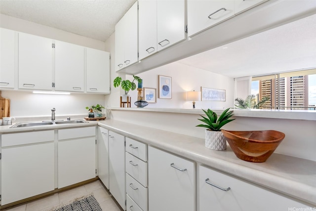 400 Hobron Ln Unit 1807, Honolulu, HI 96815 - kitchen with light countertops, white cabinets, and light tile patterned flooring
