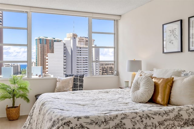 400 Hobron Ln Unit 1807, Honolulu, HI 96815 - bedroom featuring multiple windows, wood finished floors, and a view of city