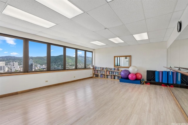 400 Hobron Ln Unit 1807, Honolulu, HI 96815 - workout room featuring a mountain view, wood finished floors, and a paneled ceiling