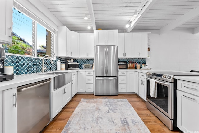 4130 Keanu St Unit 4, Honolulu, HI 96816 - kitchen featuring stainless steel appliances, track lighting, light countertops, white cabinets, and open shelves