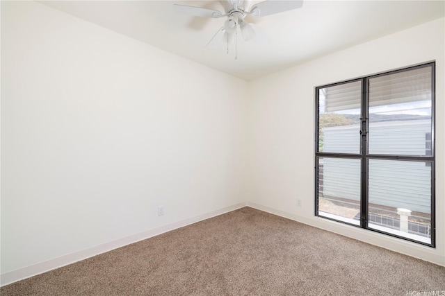 spare room with light colored carpet and ceiling fan