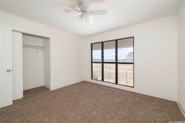 unfurnished bedroom with carpet, a closet, and ceiling fan