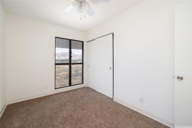unfurnished room featuring carpet flooring and a ceiling fan