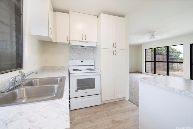 kitchen featuring white electric range oven, under cabinet range hood, light countertops, and white cabinetry