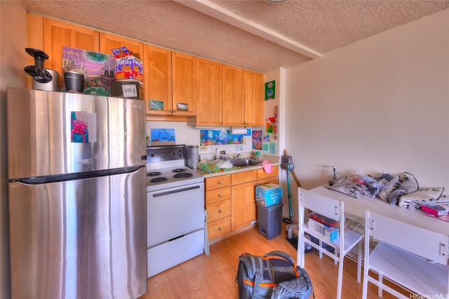 2345 Ala Wai Blvd Unit 2210, Honolulu, HI 96815 - kitchen featuring freestanding refrigerator, white electric stove, light wood-style flooring, a textured ceiling, and light countertops