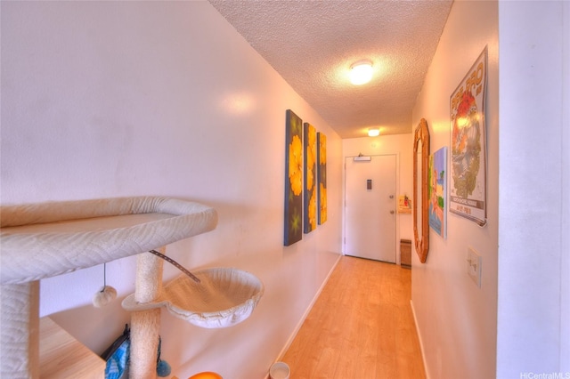 2345 Ala Wai Blvd Unit 2210, Honolulu, HI 96815 - hallway featuring a textured ceiling and light wood finished floors