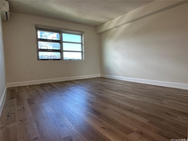 801 S St Unit 1827, Honolulu, HI 96813 - spare room featuring dark wood finished floors, a textured ceiling, baseboards, and a wall mounted AC