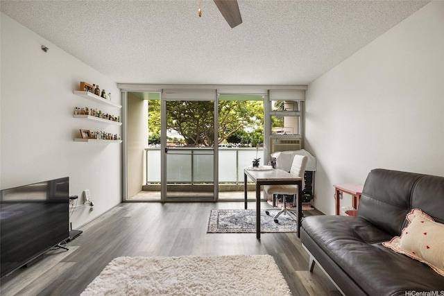 3009 Ala Makahala Pl Unit 214, Honolulu, HI 96818 - living area featuring a textured ceiling, wood finished floors, a ceiling fan, and cooling unit