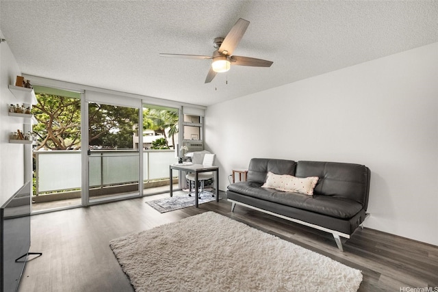 3009 Ala Makahala Pl Unit 214, Honolulu, HI 96818 - living area with ceiling fan, a textured ceiling, wood finished floors, and floor to ceiling windows