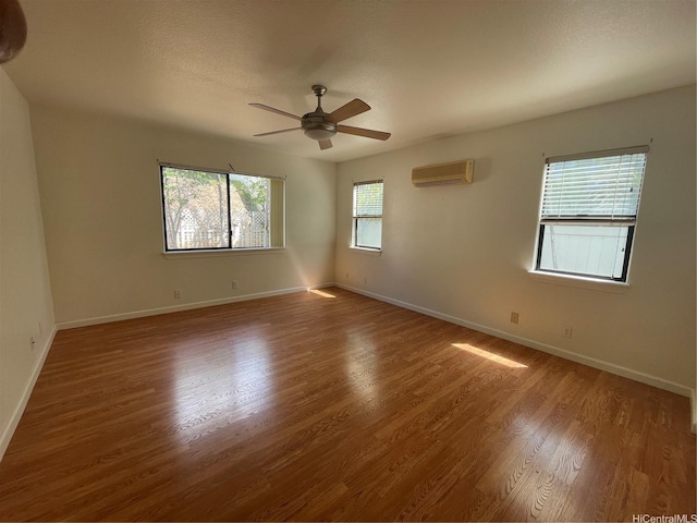 91-1088 Paaoloulu Way, Kapolei, HI 96707 - unfurnished room featuring a wall mounted air conditioner, wood finished floors, and ceiling fan
