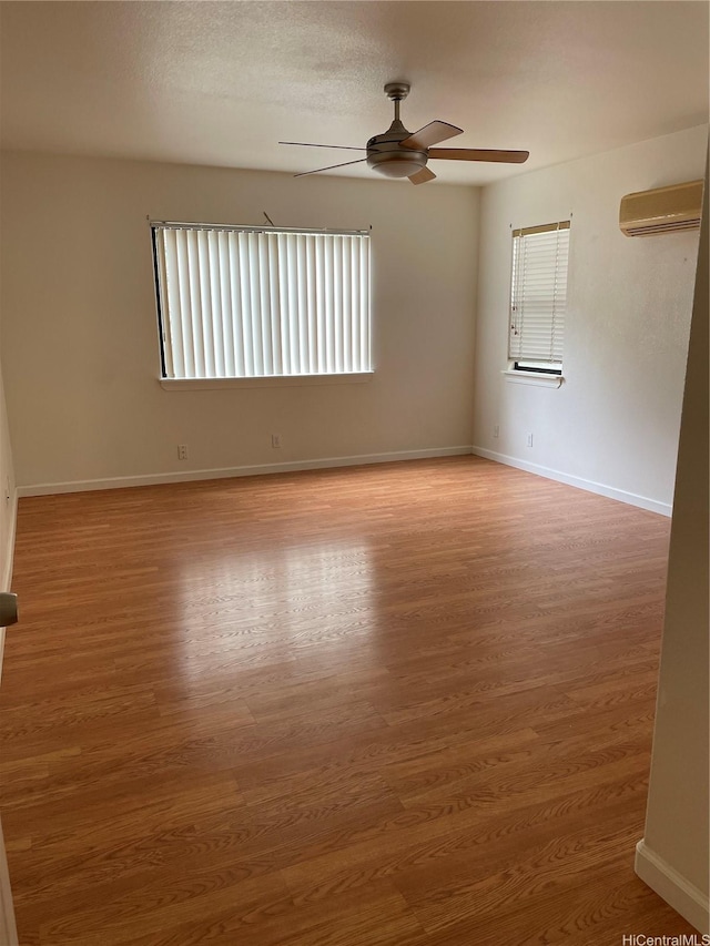 91-1088 Paaoloulu Way, Kapolei, HI 96707 - empty room with a wall unit AC, a ceiling fan, and wood finished floors