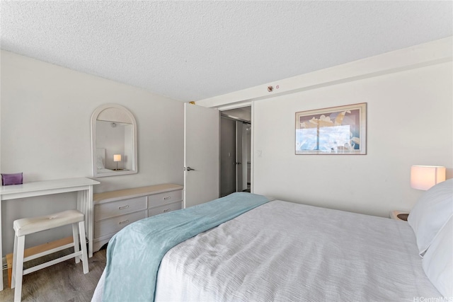445 Seaside Ave Unit 1602, Honolulu, HI 96815 - bedroom featuring wood finished floors and a textured ceiling