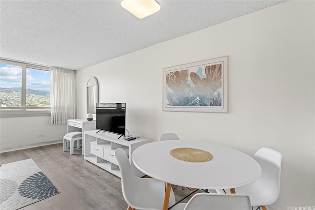 445 Seaside Ave Unit 1602, Honolulu, HI 96815 - dining room with a textured ceiling and wood finished floors