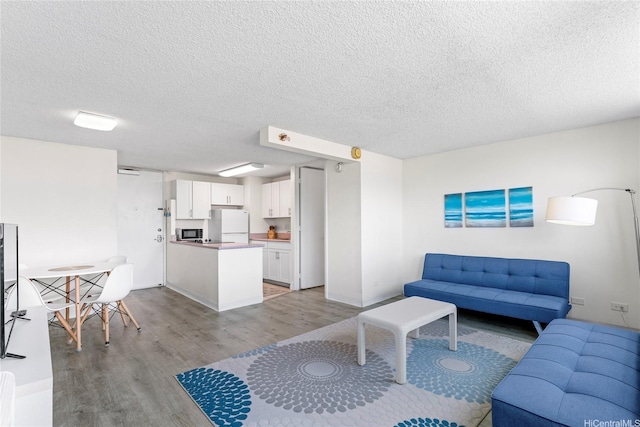 445 Seaside Ave Unit 1602, Honolulu, HI 96815 - living area featuring light wood finished floors and a textured ceiling