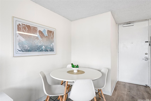 445 Seaside Ave Unit 1602, Honolulu, HI 96815 - dining space with wood finished floors and a textured ceiling
