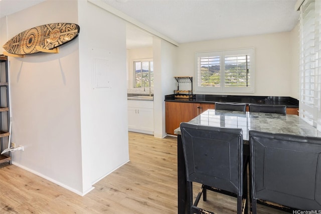 1111 Wilder Ave Pha, Pha, Honolulu, HI 96822 - kitchen featuring light wood-style flooring and brown cabinetry