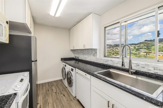 1111 Wilder Ave Pha, Pha, Honolulu, HI 96822 - kitchen featuring white appliances, washer / clothes dryer, backsplash, light wood-style flooring, and white cabinetry
