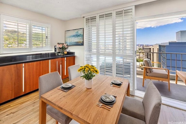 1111 Wilder Ave Pha, Pha, Honolulu, HI 96822 - dining space featuring light wood-style flooring and a bar