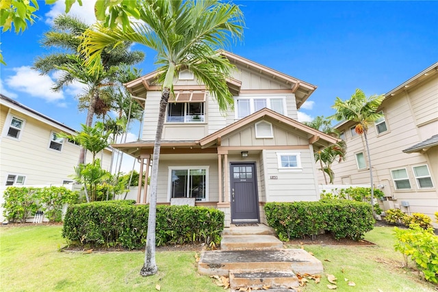 91-6438 Kapolei Pkwy, Ewa Beach, HI 96706 - view of front of house with board and batten siding and a front lawn