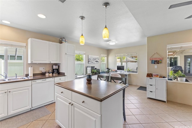 91-6438 Kapolei Pkwy, Ewa Beach, HI 96706 - kitchen featuring white dishwasher, dark countertops, light tile patterned floors, white cabinetry, and recessed lighting