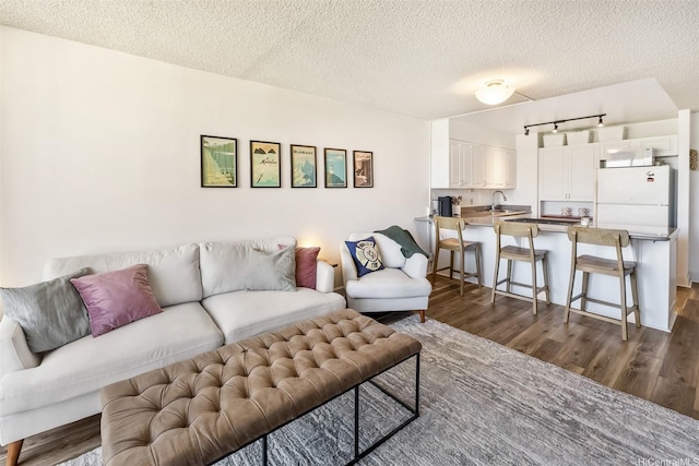 3045 Ala Napuaa Pl Unit 1803, Honolulu, HI 96818 - living area with dark wood finished floors, a textured ceiling, and rail lighting