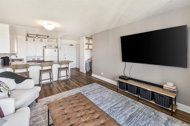 3045 Ala Napuaa Pl Unit 1803, Honolulu, HI 96818 - living area featuring dark wood-style floors and a textured ceiling