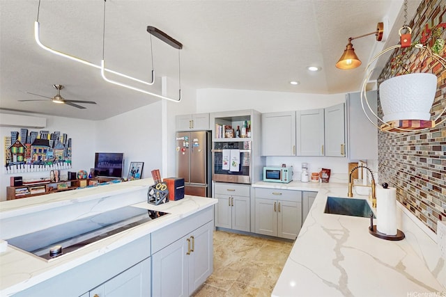 92-759 Lihau St, Kapolei, HI 96707 - kitchen featuring appliances with stainless steel finishes, light stone counters, decorative light fixtures, ceiling fan, and vaulted ceiling