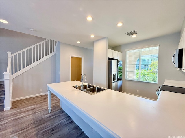 91-2220 Kaiwawalo St Unit 11-1105, Ewa Beach, HI 96706 - kitchen featuring stainless steel appliances, dark wood finished floors, white cabinets, recessed lighting, and light countertops
