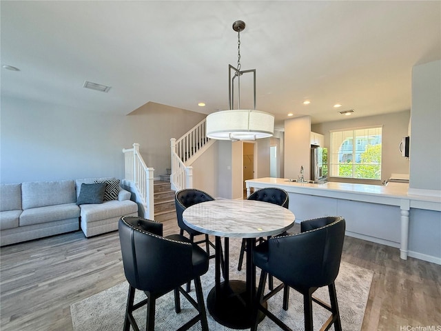 91-2220 Kaiwawalo St Unit 11-1105, Ewa Beach, HI 96706 - dining space with light wood-style flooring, stairs, and recessed lighting