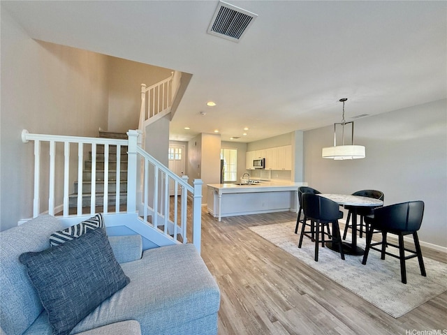 91-2220 Kaiwawalo St Unit 11-1105, Ewa Beach, HI 96706 - living area featuring light wood-style floors, stairway, and recessed lighting