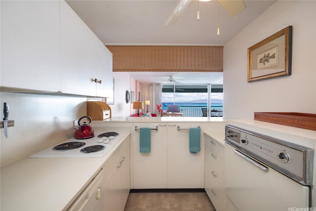 2877 Kalakaua Ave Unit 804, Honolulu, HI 96815 - kitchen with a ceiling fan, white appliances, light countertops, and white cabinetry