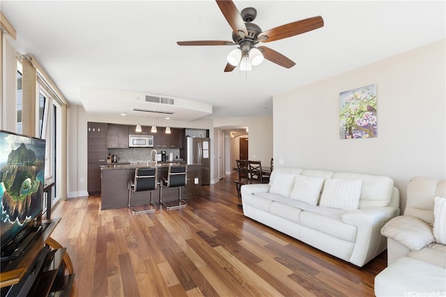 1837 Kalakaua Ave Unit 2001, Honolulu, HI 96815 - living area featuring arched walkways, a ceiling fan, and wood finished floors