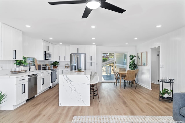 1076 Ilima Dr Unit A, Honolulu, HI 96817 - kitchen featuring appliances with stainless steel finishes, a kitchen bar, ceiling fan, white cabinetry, and recessed lighting