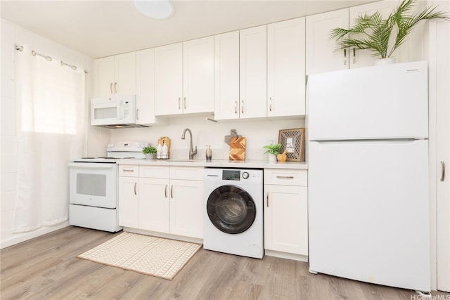 1808 Waiola St Unit 6, Honolulu, HI 96826 - kitchen with white appliances, washer / dryer, light countertops, light wood-type flooring, and white cabinetry