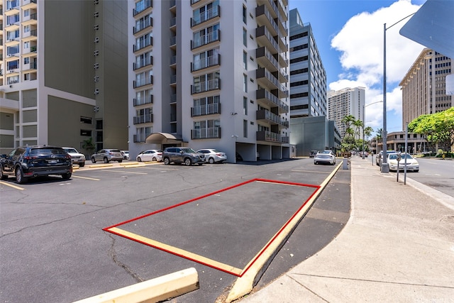 731 Amana St Unit 703, Honolulu, HI 96814 - view of apartment building / complex featuring uncovered parking and a view of city